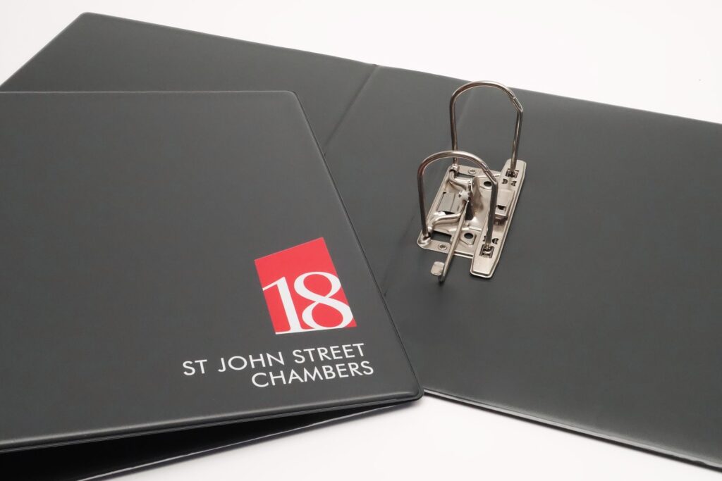 Lever arch ring binder in black PVC with simple company branding in white and red print to cover.
