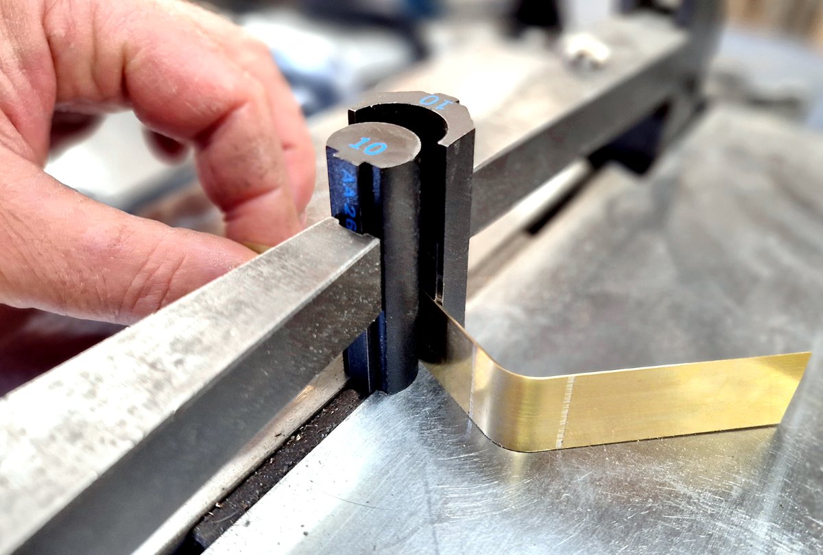 Close-up of a Duraweld tool maker forming a brass component for a bespoke high-frequency welding tool.