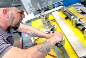 Skilled Duraweld operator setting specialist manufacturing equipment for accurate production.
