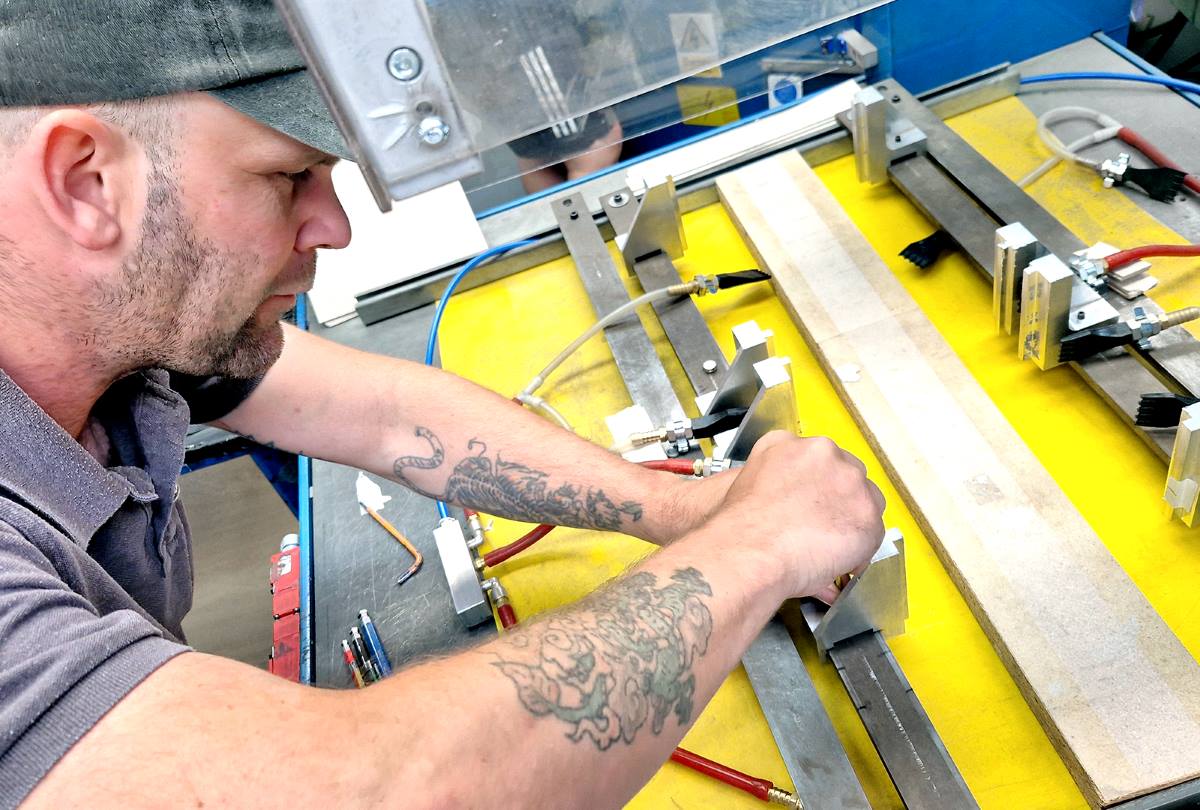 Skilled Duraweld operator setting specialist manufacturing equipment for accurate production.